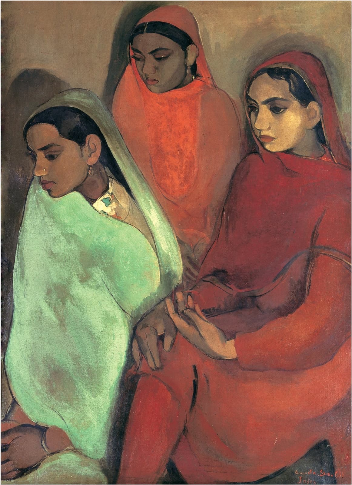 Three young women sit close together against a plain ochre-brown wall. On the left a woman in profile facing left is wrapped from head to lap in pale green cloth, with a gold nose stud, a drop earring and lowered eyes. Behind her a woman in orange-red looks down with her head covered. On the right a paler woman in deep crimson looks to the left with large dark eyes; her open hand rests at the centre over the second woman's darker hand. The signature Amrita Sher-Gil, Indes, is in red at the lower right