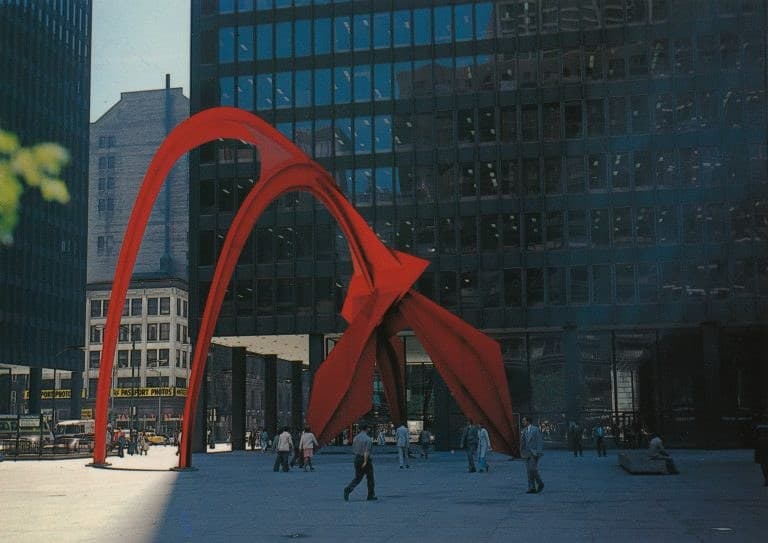 Flamingo: a monumental vermilion steel stabile of arching curved legs and ribs standing on a granite plaza between dark glass towers
