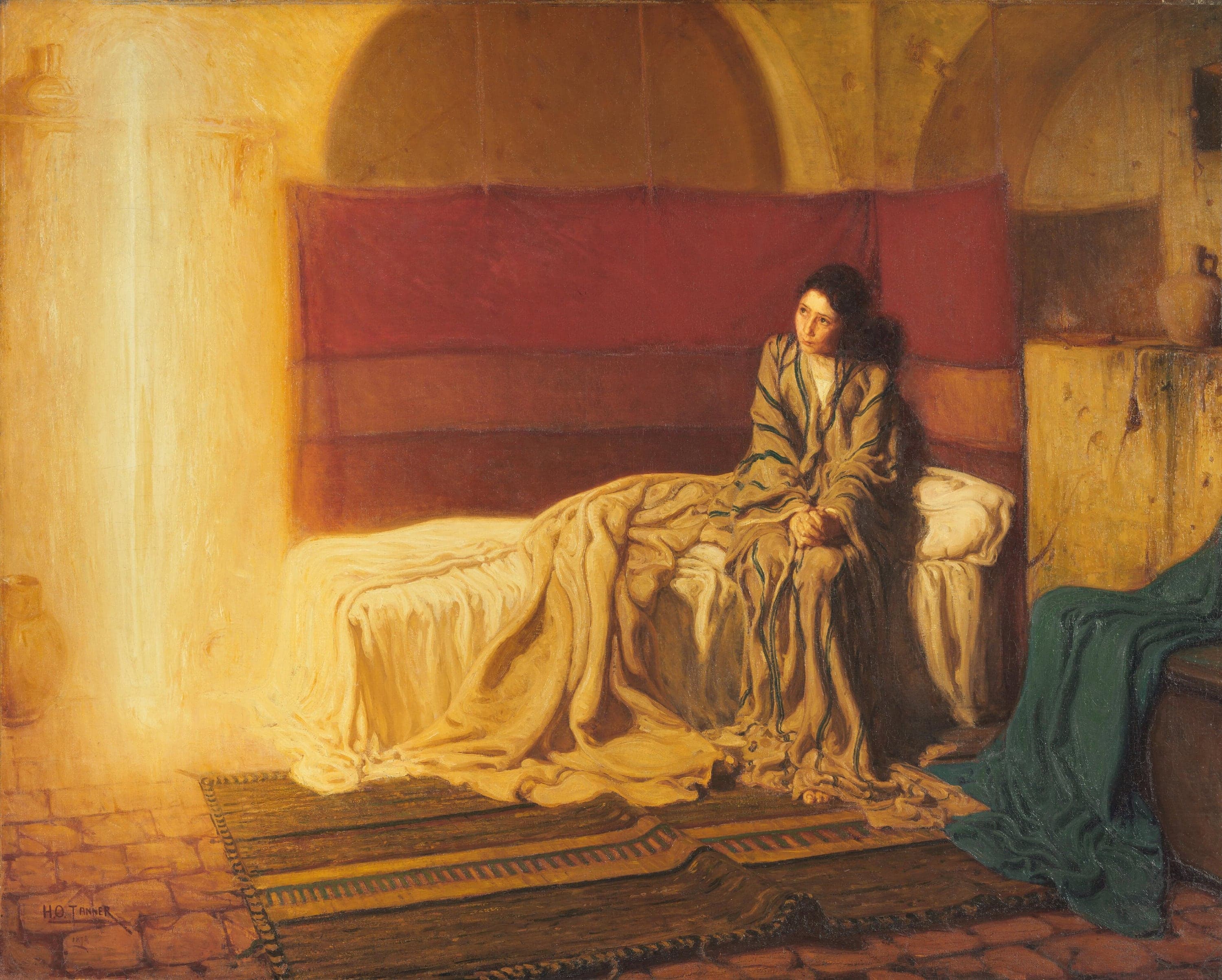A vaulted stone room lit in gold. A tall column of white-gold light stands in the left corner from the floor almost to the top of the canvas. To the right of centre a dark-haired girl in a beige robe with blue-green stripes sits on the edge of a bed with her hands clasped in her lap and her bare feet on a striped rug, looking towards the light. A red cloth hangs on the wall behind her under a shallow arch, the bedclothes are heaped in white and gold, a green cloth is draped over a chest at the lower right, and a clay jar stands on the stone floor at the far left