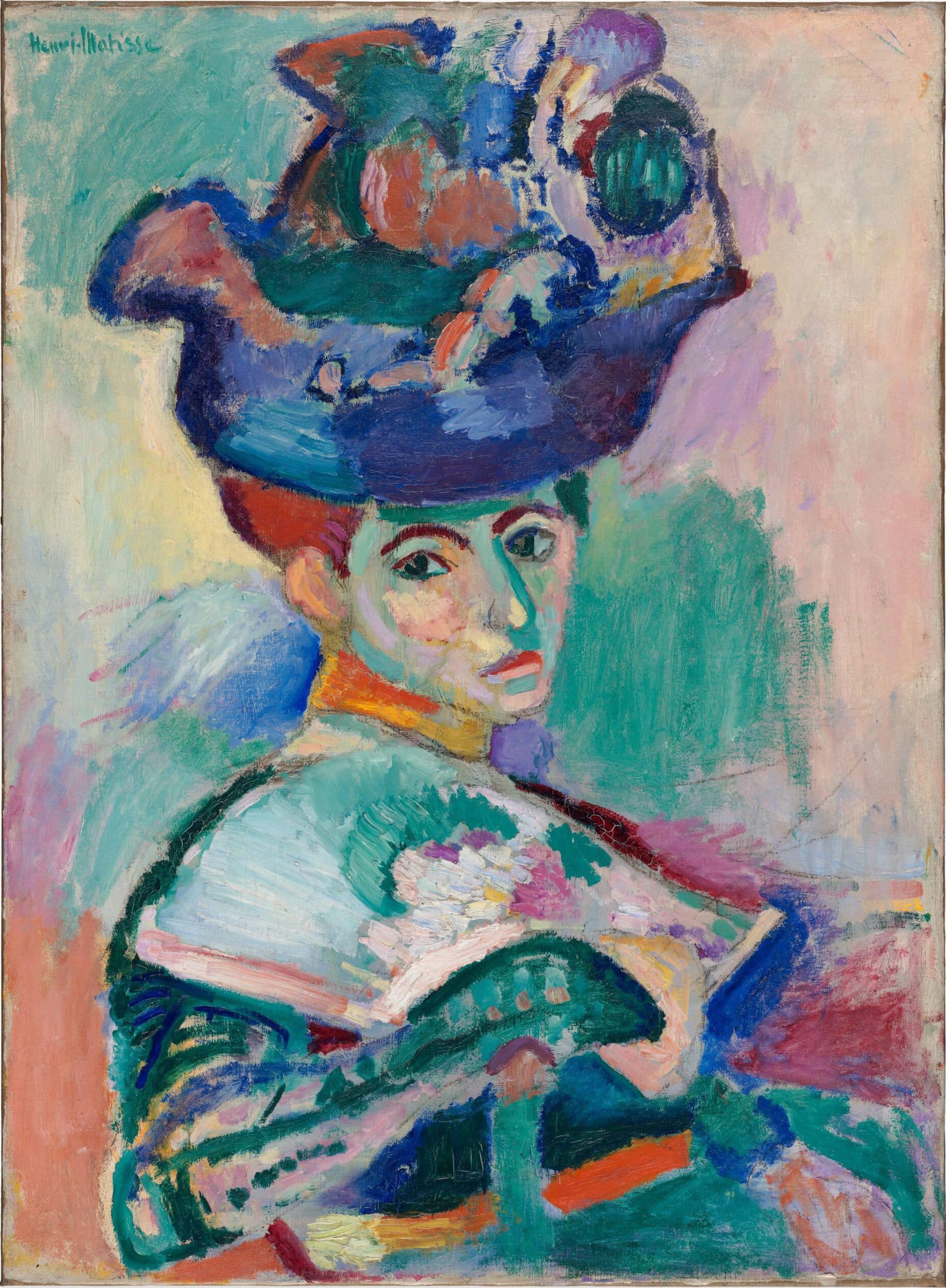 Henri Matisse's Woman with a Hat: Amélie Matisse sits in profile and turns toward the viewer beneath an enormous hat, her face, dress, fan, and background built from loose strokes of green, pink, orange, blue, and violet