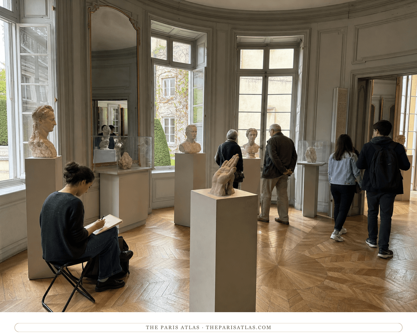 Visitors and an art student among portrait and hand studies in a curved Hôtel Biron gallery