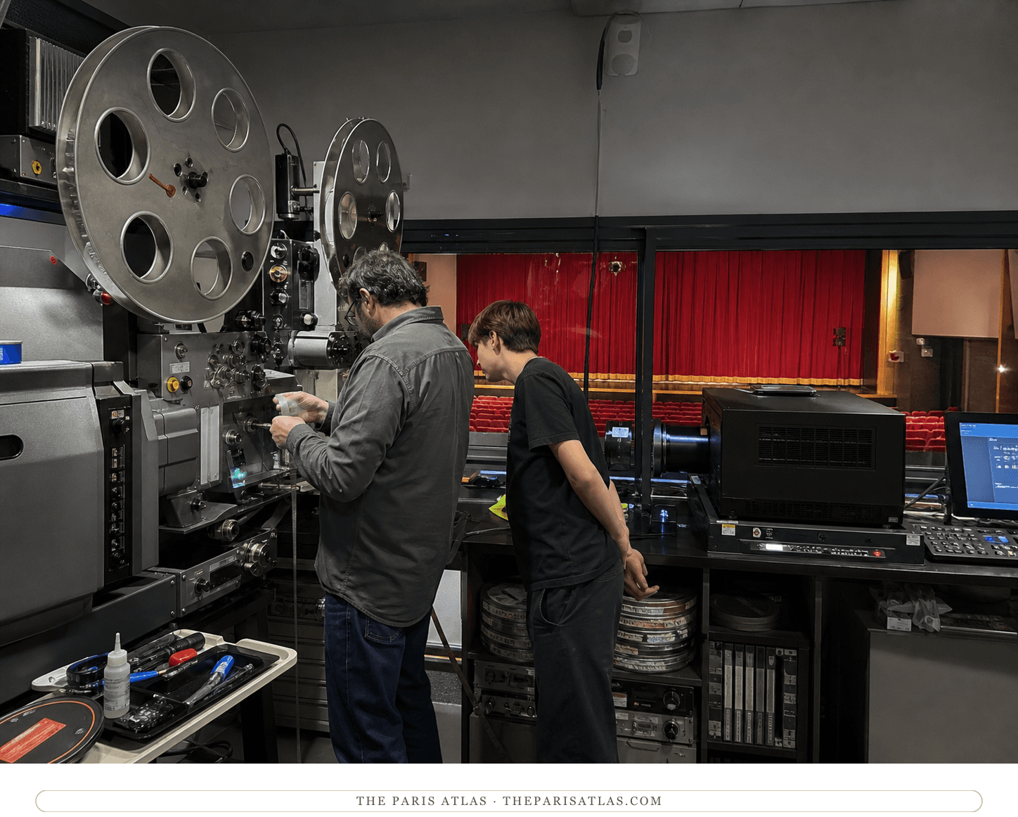 Projectionist and trainee beside 35mm and digital projectors at Studio des Ursulines