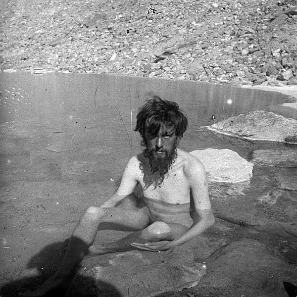 Aleister Crowley bathing in a mountain spring during the 1902 K2 expedition