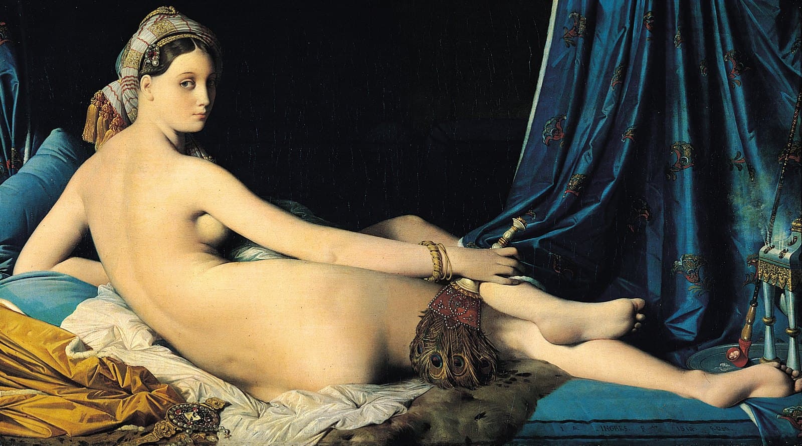 Reclining nude woman seen from behind on blue silk, turning her head over her shoulder, holding a peacock fan, wearing a turban