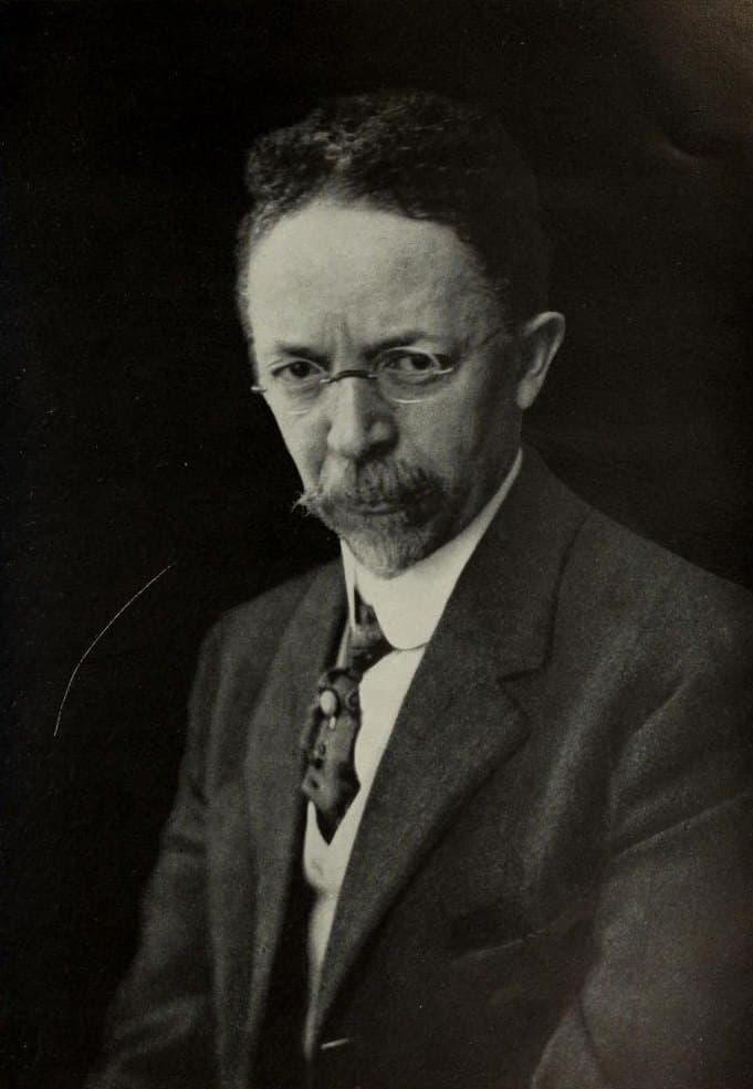 Henry Ossawa Tanner in a dark suit, seated and facing the camera