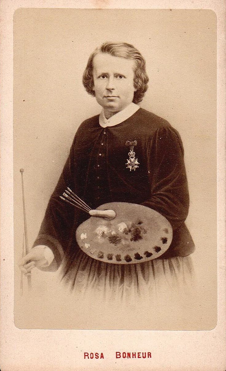 Rosa Bonheur holding a palette and brushes and wearing her Légion d’honneur medal.