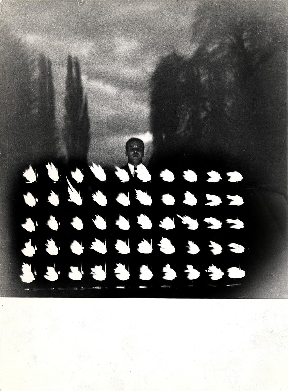 Yves Klein standing beside the flames of his Wall of Fire in 1961