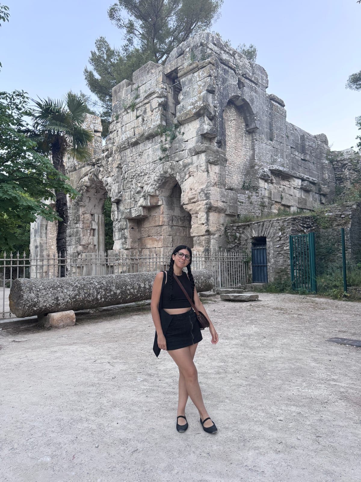 Adriana in front of the stone ruins at Nîmes
