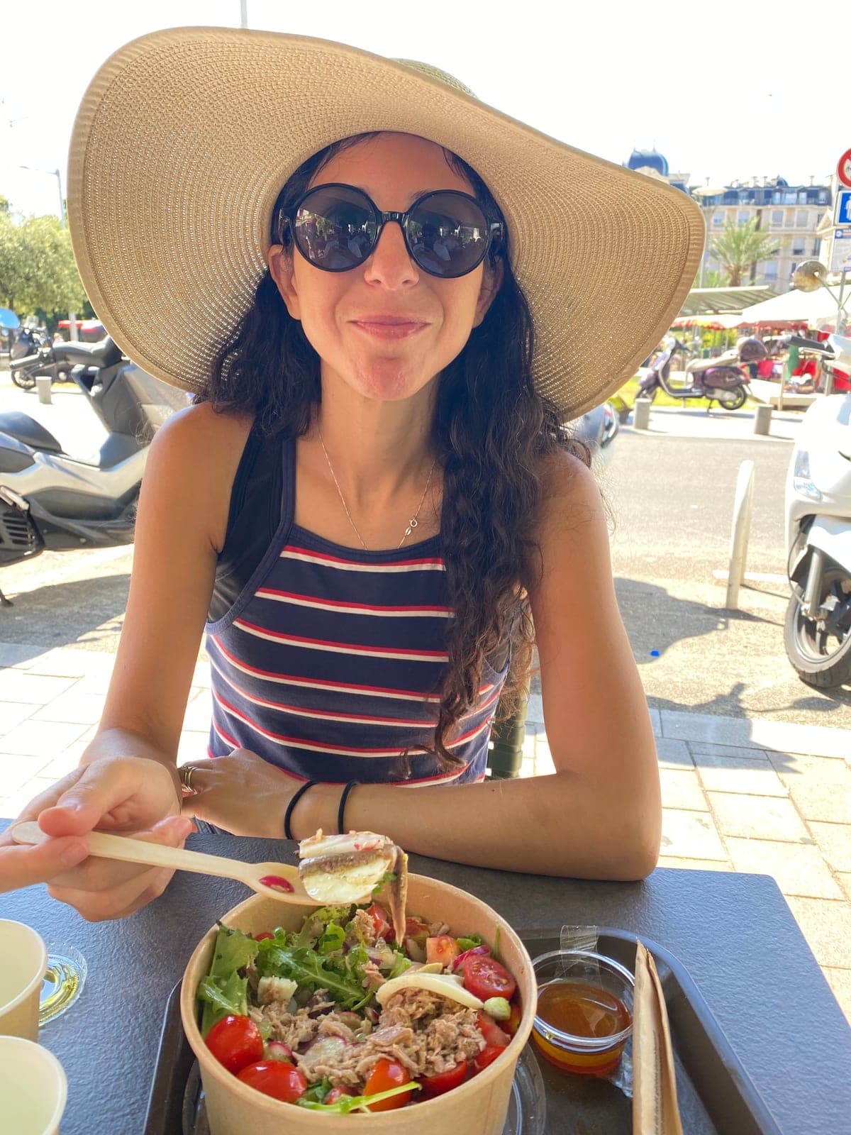 Adriana at a sidewalk table with a niçoise salad, place du Général de Gaulle, Nice