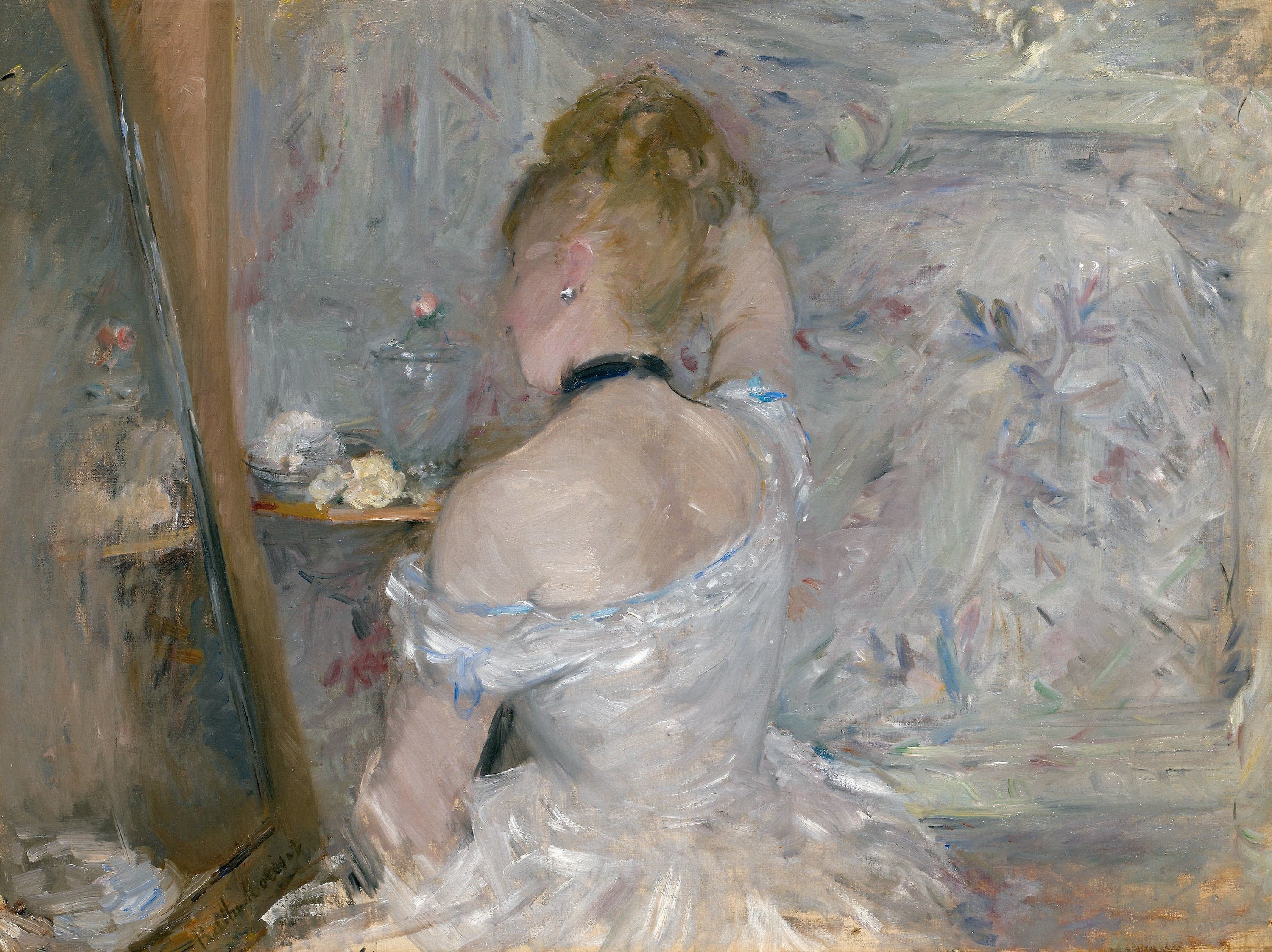 Berthe Morisot's Woman at Her Toilette: a fair-haired woman seen from behind at a dressing table in a pale off-the-shoulder dress and black neck ribbon, one arm raised toward her hair, a tall blue-gray mirror at the left giving back no clear reflection