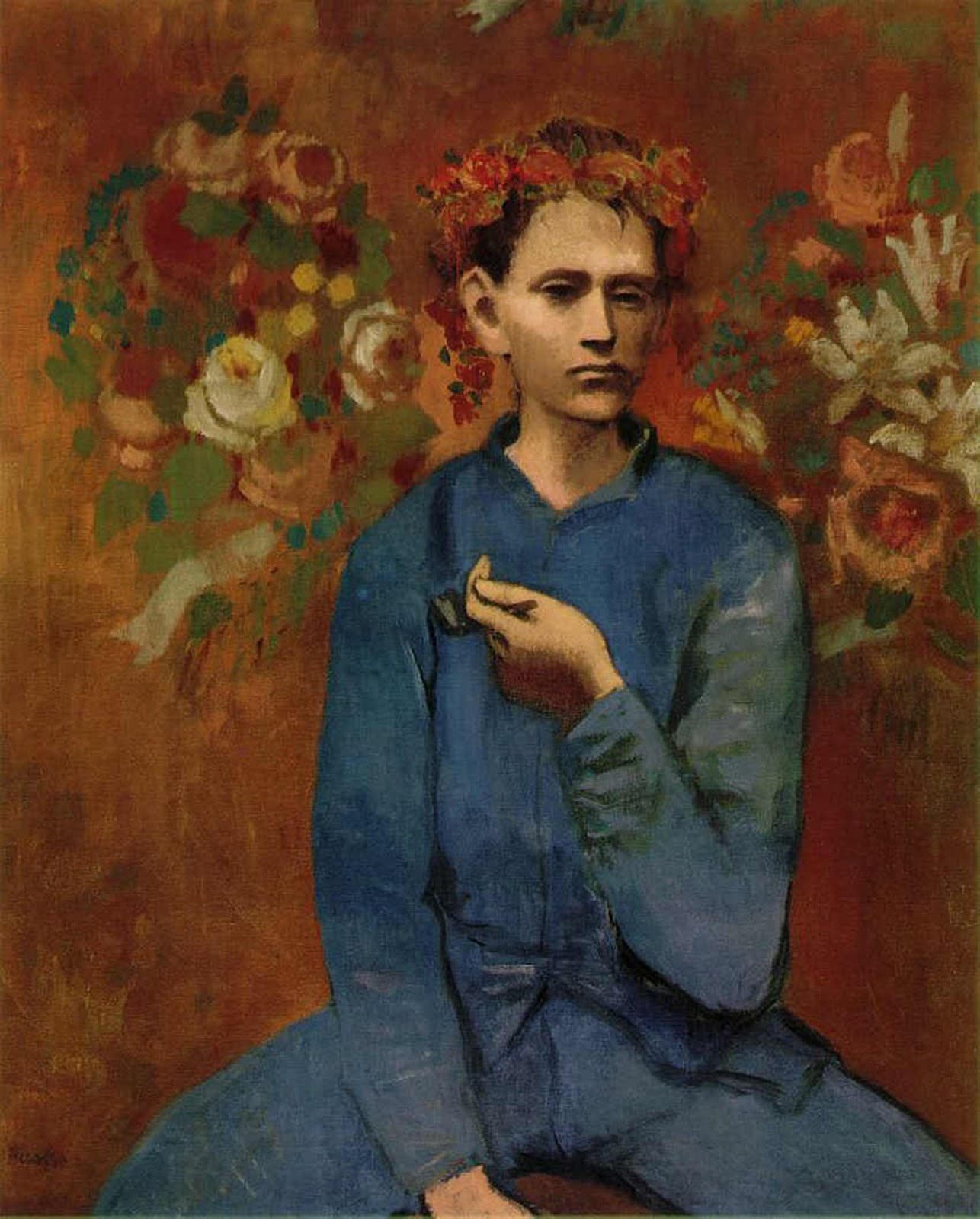 A seated young man in blue coveralls with a garland of roses on his head, holding a pipe in his left hand, against a reddish wall painted with bouquets of flowers