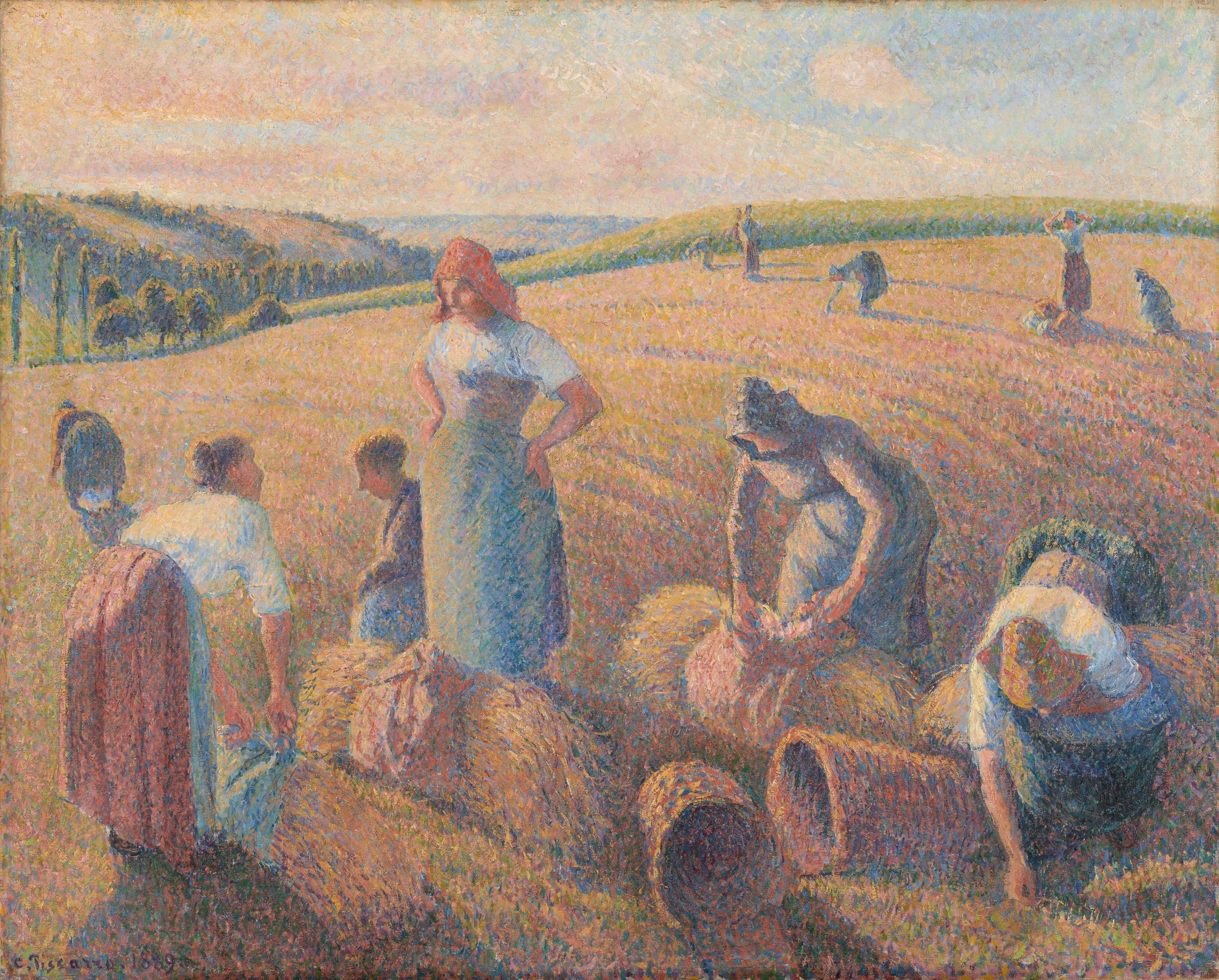 Camille Pissarro's 1889 painting of women gleaning a cut wheatfield in evening light, one standing with her hands on her hips among figures bent over the stubble, two woven baskets lying in the foreground and more gleaners scattered up the slope behind