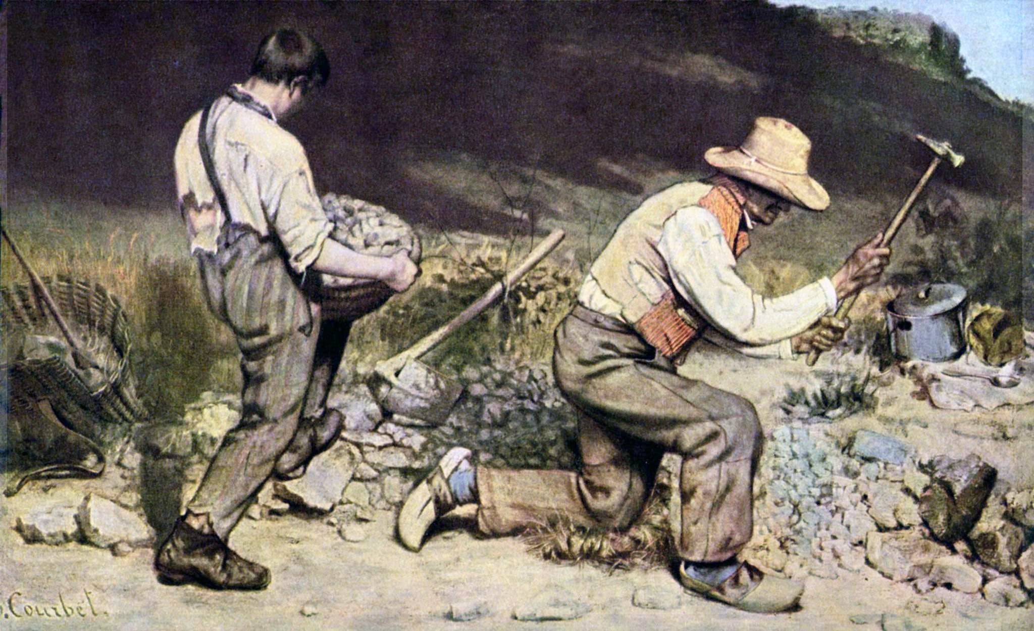 Close view of the kneeling man's raised arm holding a long-handled stone hammer at the top of its arc against a dark hillside
