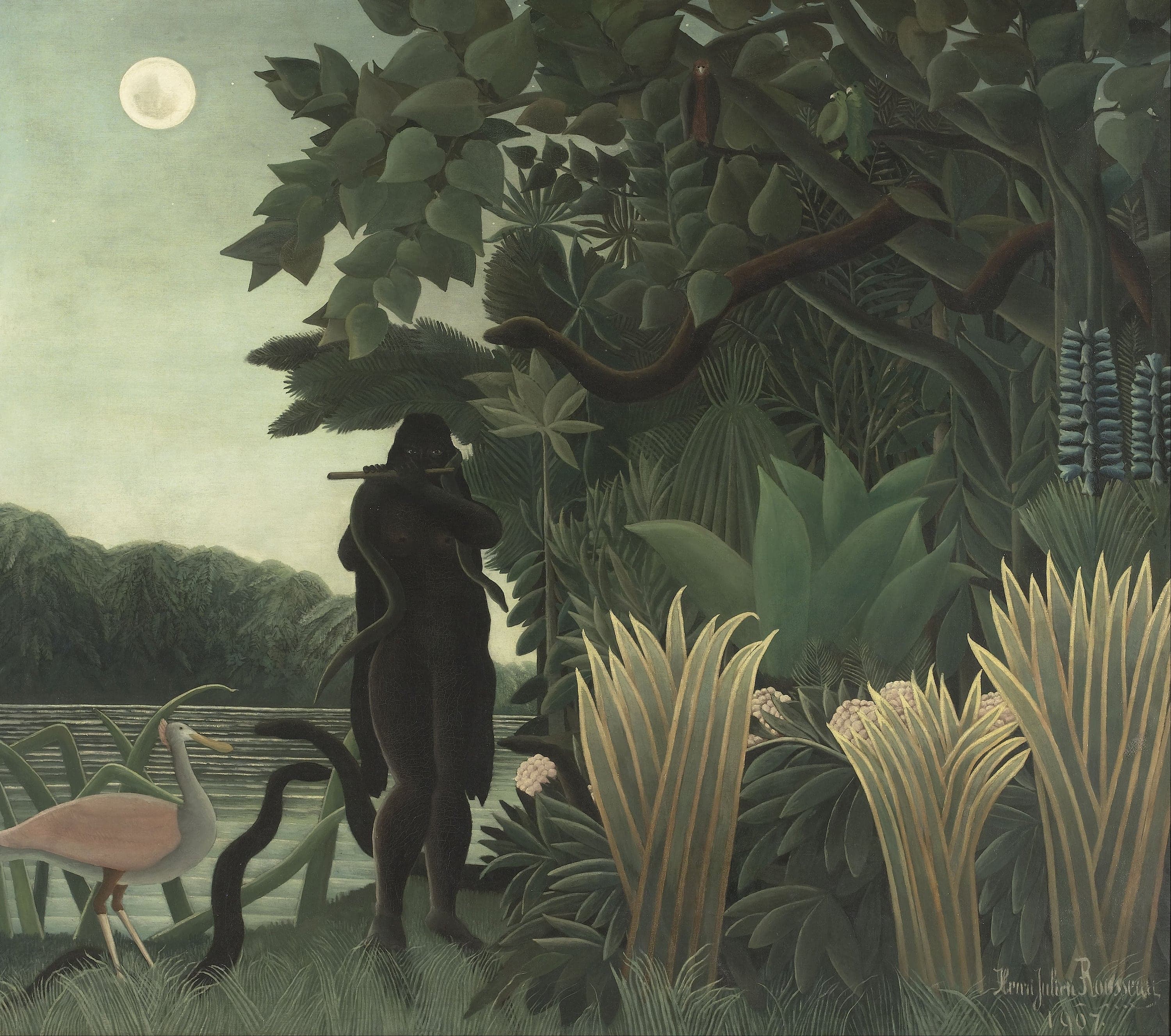 A nude woman painted as a near-black silhouette stands at a riverbank playing a wooden pipe, a snake across her shoulders and another curling up from the grass, with a full moon in a pale grey-green sky and a pink spoonbill wading at the left