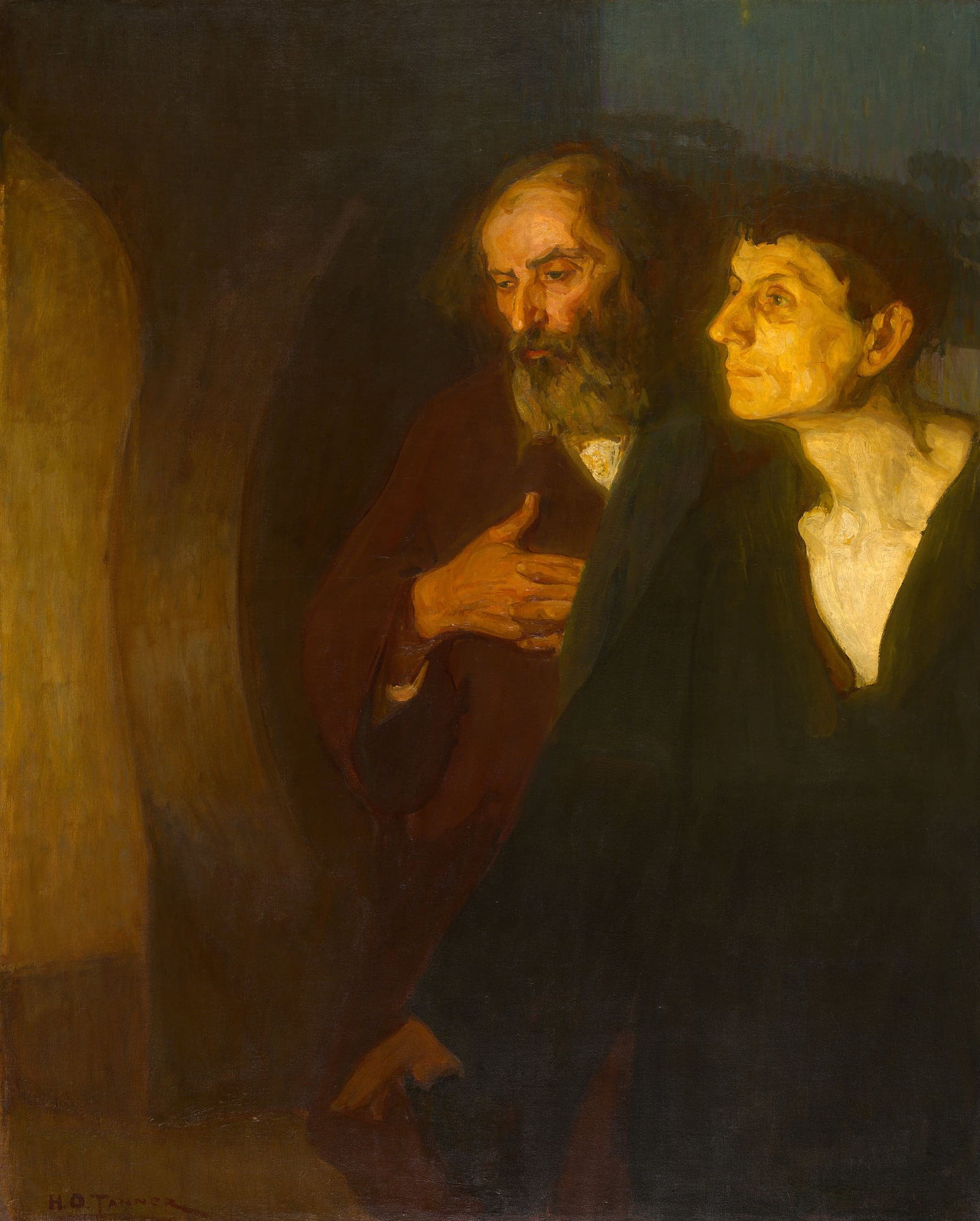 Two men stand side by side in a dark interior, cut off at the waist by the bottom edge, both looking towards a band of golden light at the left edge of the picture. The older man, nearer the centre, has a bald crown, a long grey-brown beard and a furrowed brow, wears a dark red robe and clasps his hands against his chest with his eyes cast down. The younger man at the right, beardless and dark-haired, wears a dark green robe over a white shirt open at the throat and lifts his face, lit flat yellow, towards the light. The background is a bare wall in brown shadow