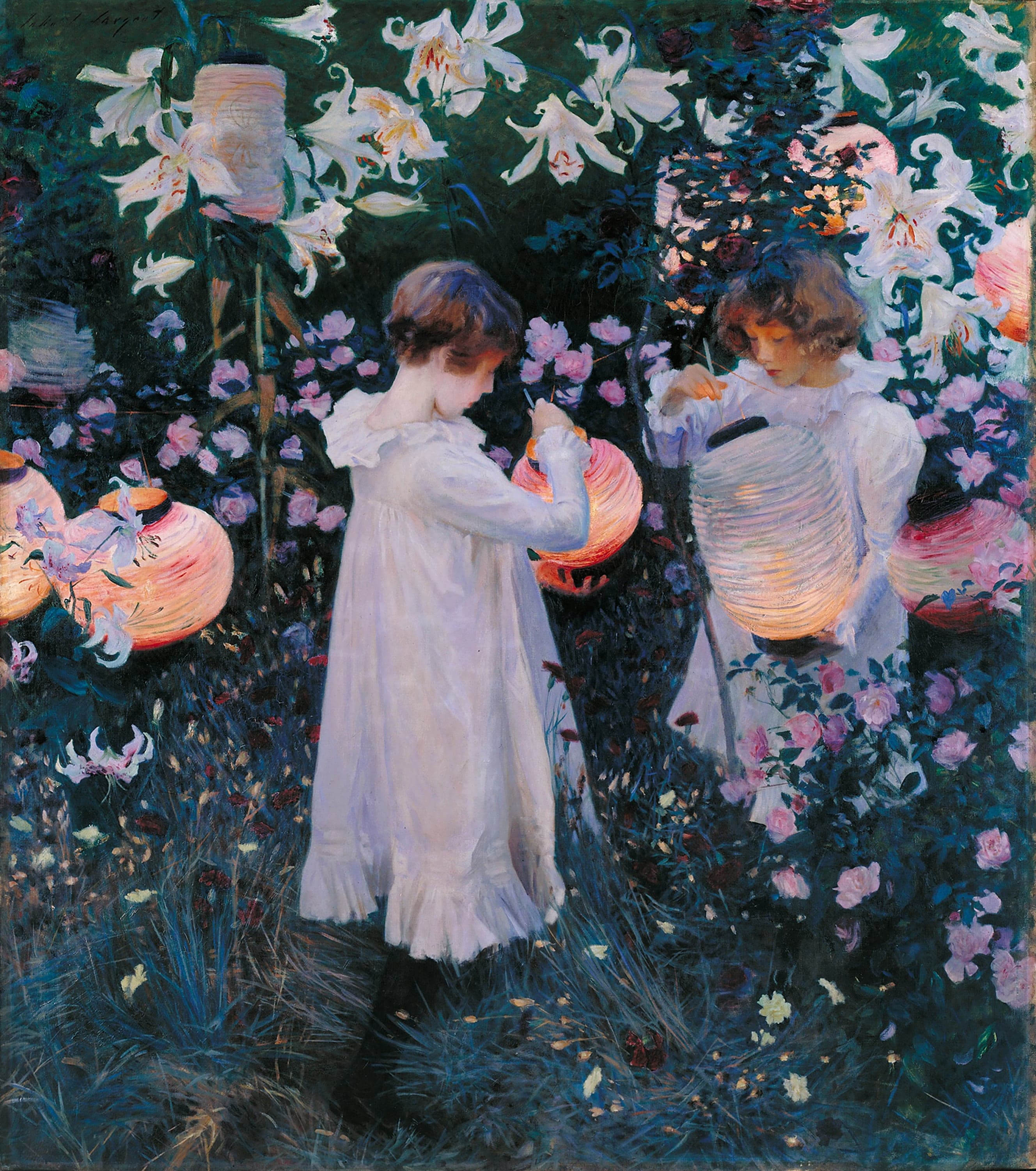 Two girls in long white dresses stand in a dusk garden among tall white lilies, pink roses and carnations; the older one on the left holds a glowing Chinese paper lantern and the younger on the right reaches into a second one, with more lit lanterns hanging in the dark foliage around them.