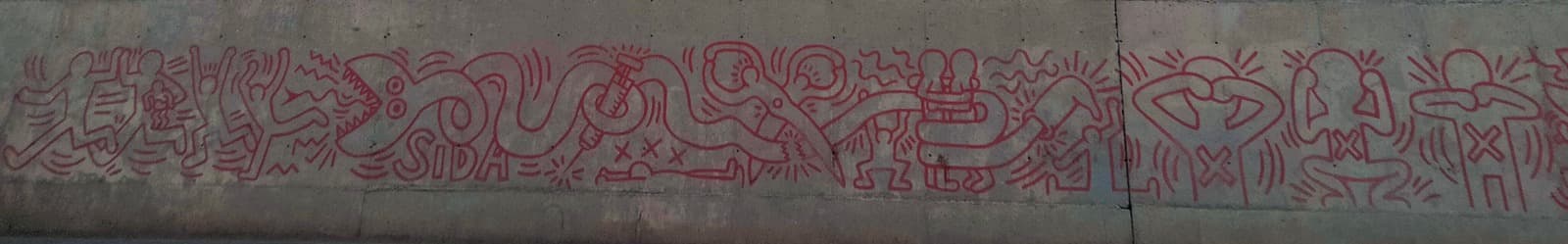 A long low band of red line drawing running along a grey concrete wall, with no colour in it but red. A serpent with a row of sawtooth points for a jaw and two round stacked eyes crosses the band at the left, and its looping body forms the outlined capitals SIDA. A syringe with a barrel, plunger and needle is drawn inside one loop, with three X marks in a row below it above a figure lying flat on its back. A pair of scissors with two round finger loops cuts the serpent at the centre, leaving a jagged severed end. At the right three figures stand in a row with a large X on each torso, one covering its eyes, one its ears and one its mouth