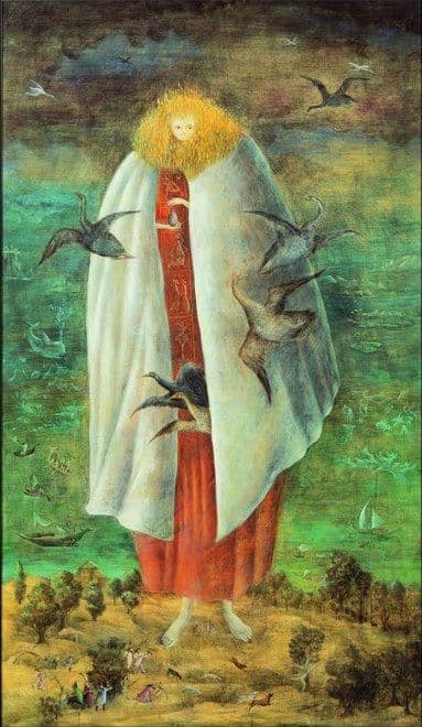 A tall narrow panel filled by a single standing woman whose bare feet are planted on a golden-ochre plain and whose head reaches the top of the picture. Her small pale face sits at the centre of a broad oval of golden-yellow that stands up in fine spikes all round it. A stiff cream-white cape spreads from her shoulders on both sides, opening over a rust-red robe whose front band is divided into compartments holding small pale bird-headed figures. Two small hands come out of the cape high on her chest and cup a dark speckled egg. Geese fly out of the cape at both sides, slate-blue and tawny, and more fly in the dark olive sky. Behind her a flat green sea carries pale ghostly shapes and small dark sailing boats, and tiny figures in coloured robes move among scrubby trees at her feet