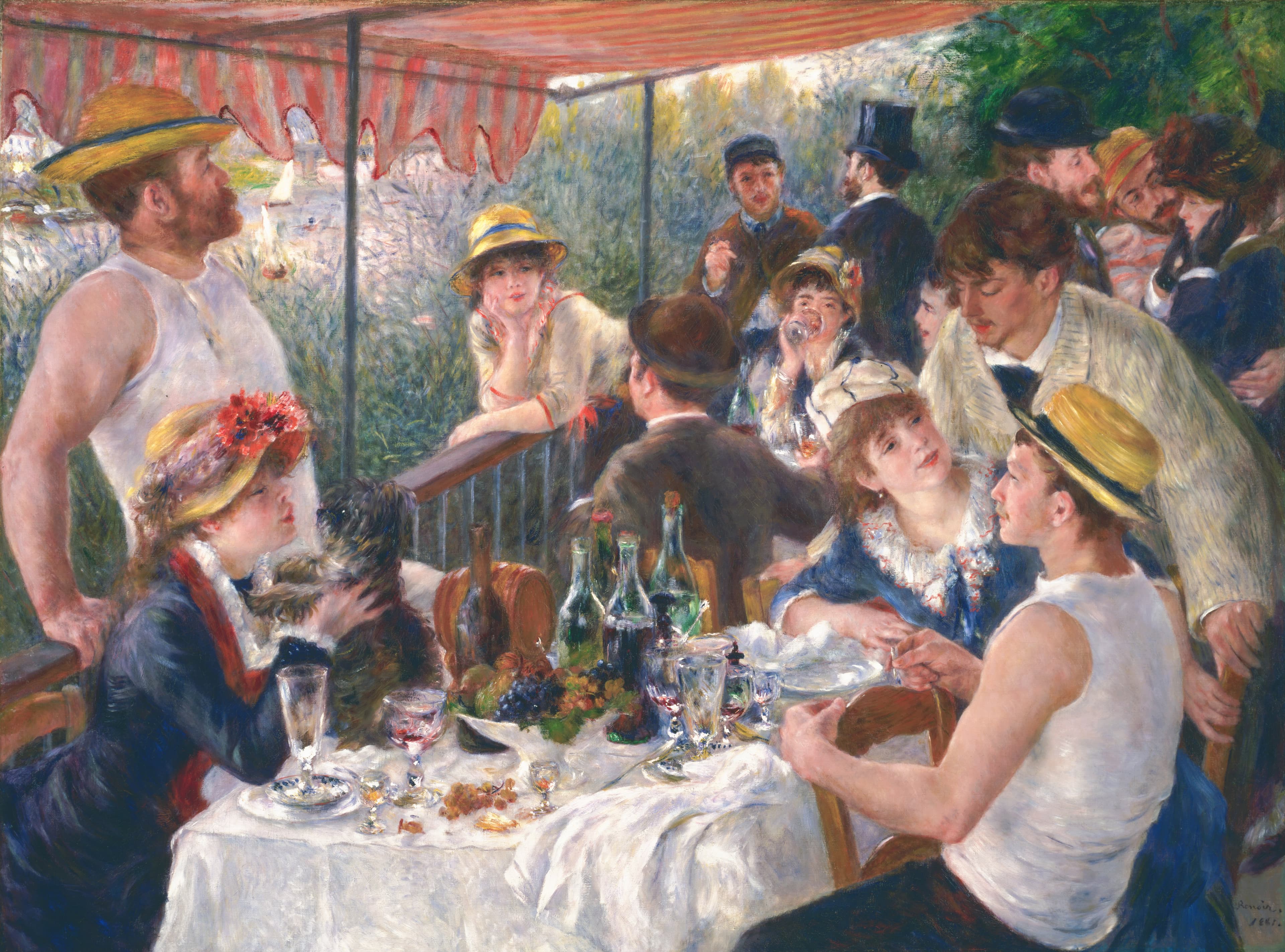 Friends at a table under a striped awning, a woman holding a dog at left and a seated man in a straw hat at right