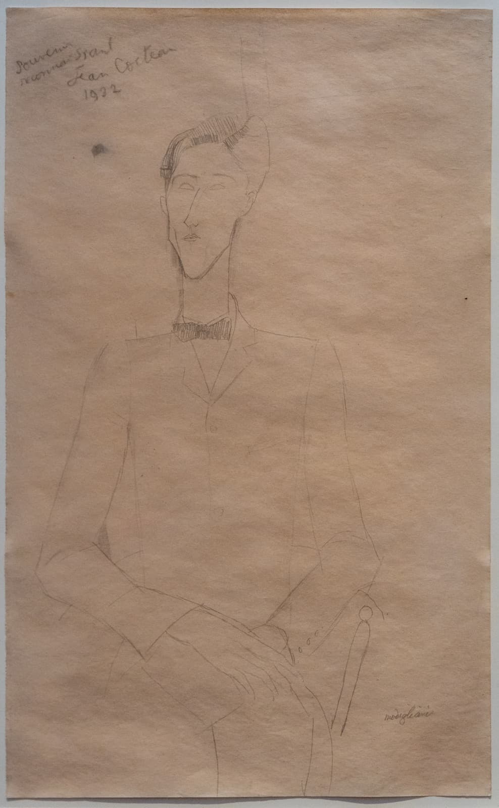 Modigliani's 1916 portrait of Jean Cocteau — elongated, poised, seated in a dark suit against gray panels