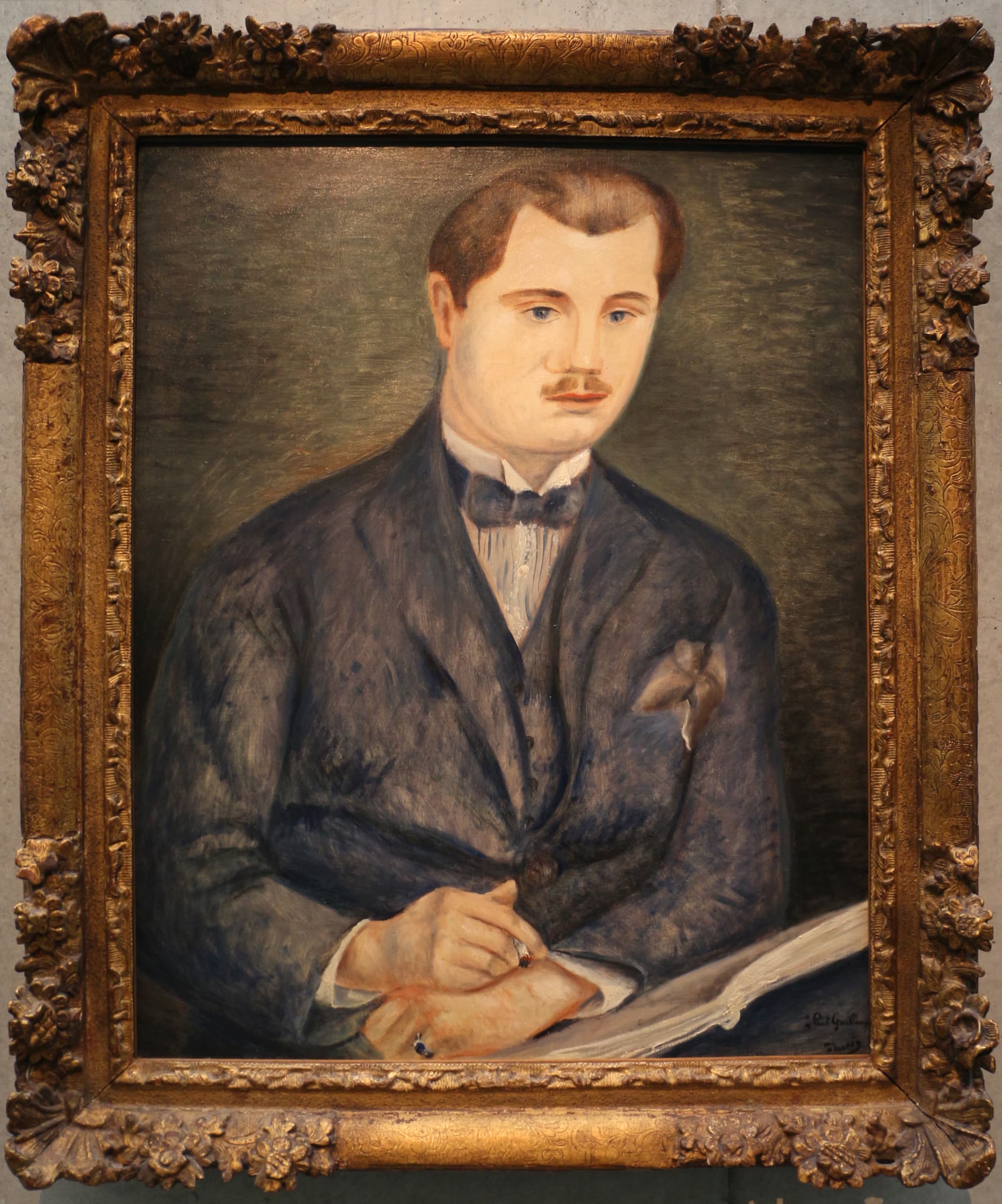 Framed portrait of Paul Guillaume in three-quarter view, blue suit and bow tie, cigarette in his left hand, leaning on an open book against a blue-green ground