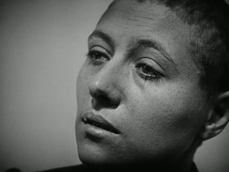 Renée Falconetti as Joan, head shorn, looking up with a tear on her cheek, in extreme close-up