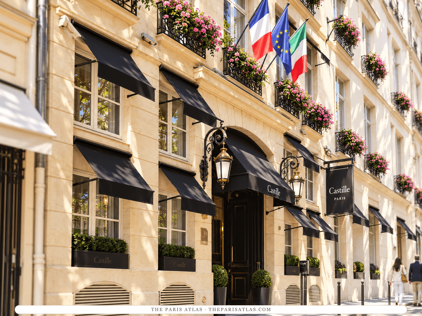 Reference-based illustration of the entrance of Castille Paris on rue Cambon: a pale stone façade with black awnings and flower boxes, a pair of lanterns by the arched door, a hanging Castille sign and flags above.