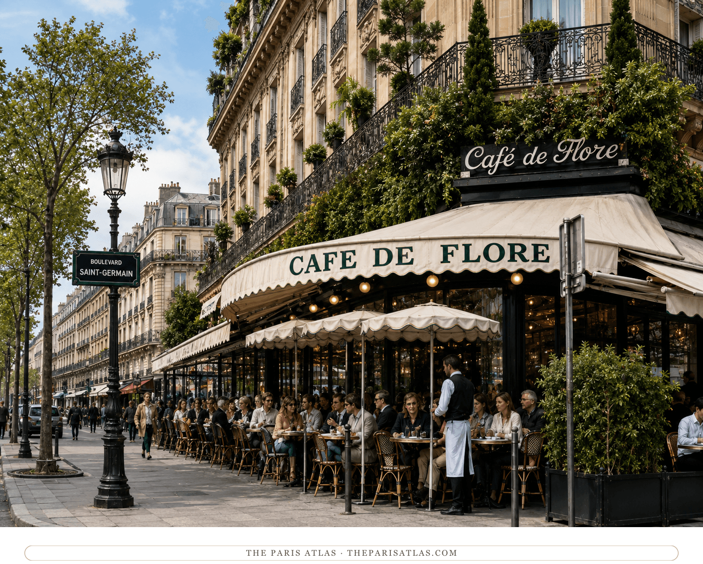 The Café de Flore today, white awning and red seats behind the terrace planters