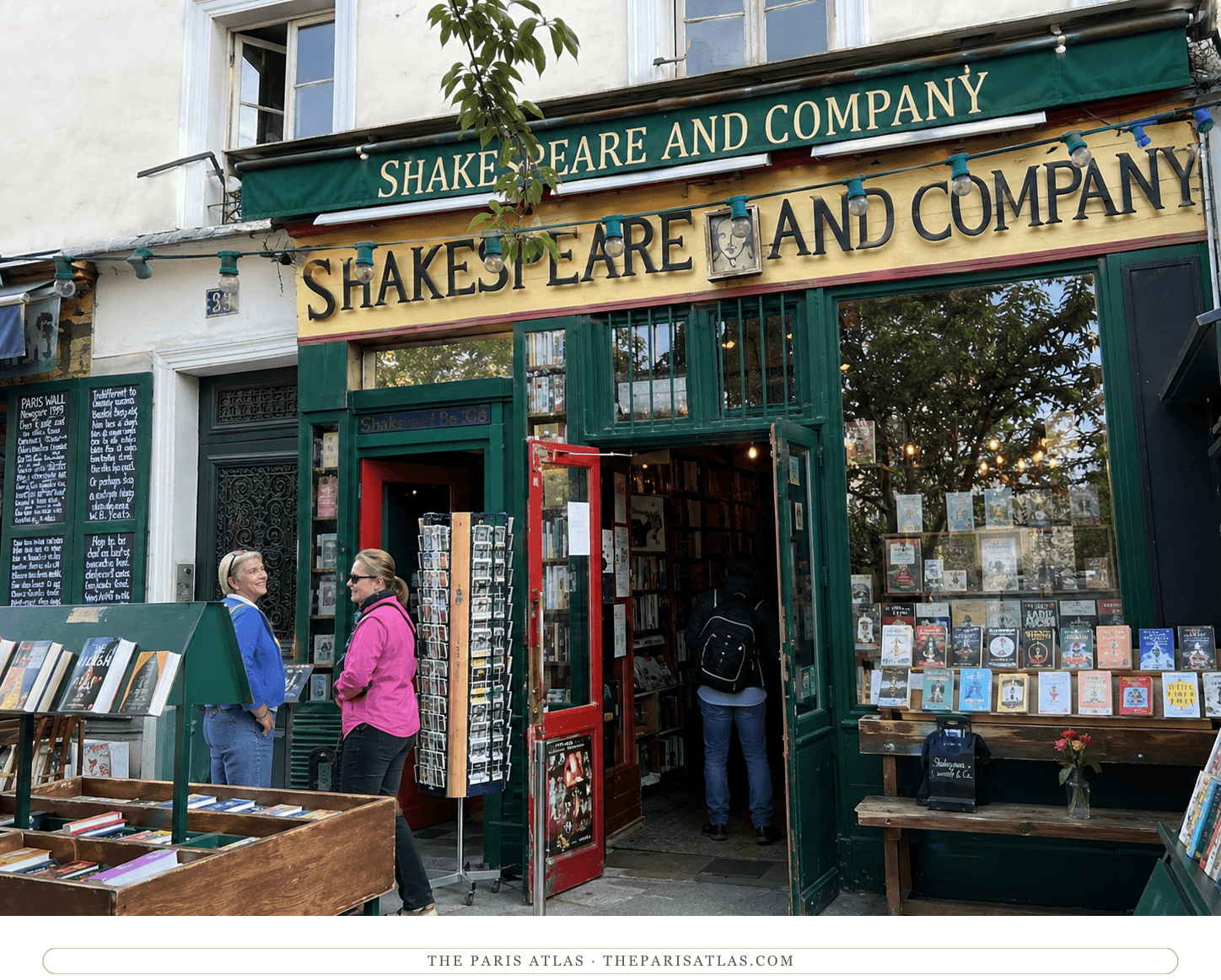 The successor Shakespeare and Company bookshop today, green shopfront with browsers at the outdoor book bins