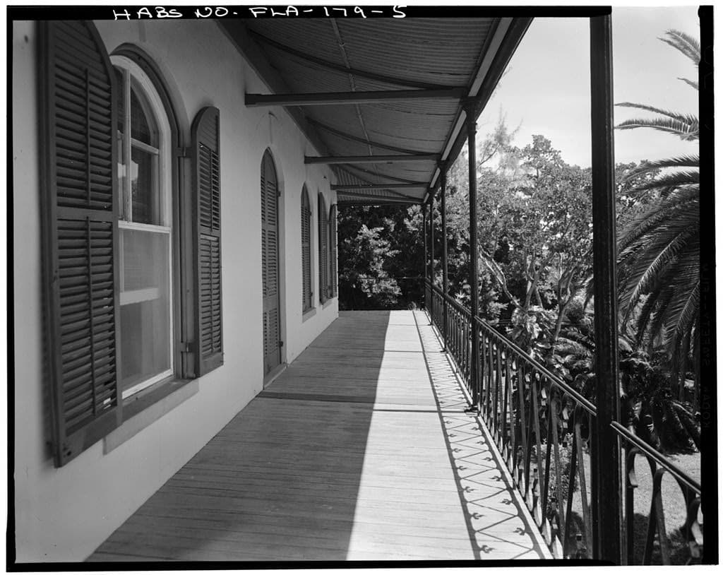 Black-and-white 1967 view along the shaded second-story veranda of the Ernest Hemingway House