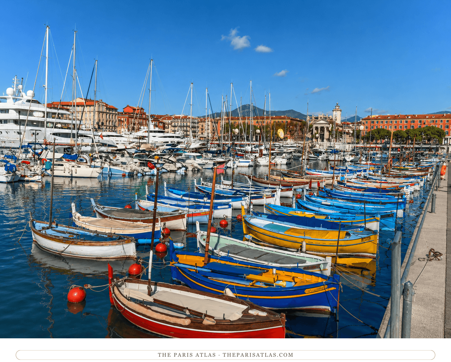 The same view of the port of Nice in colour, ochre and pink houses along the quay under a blue sky