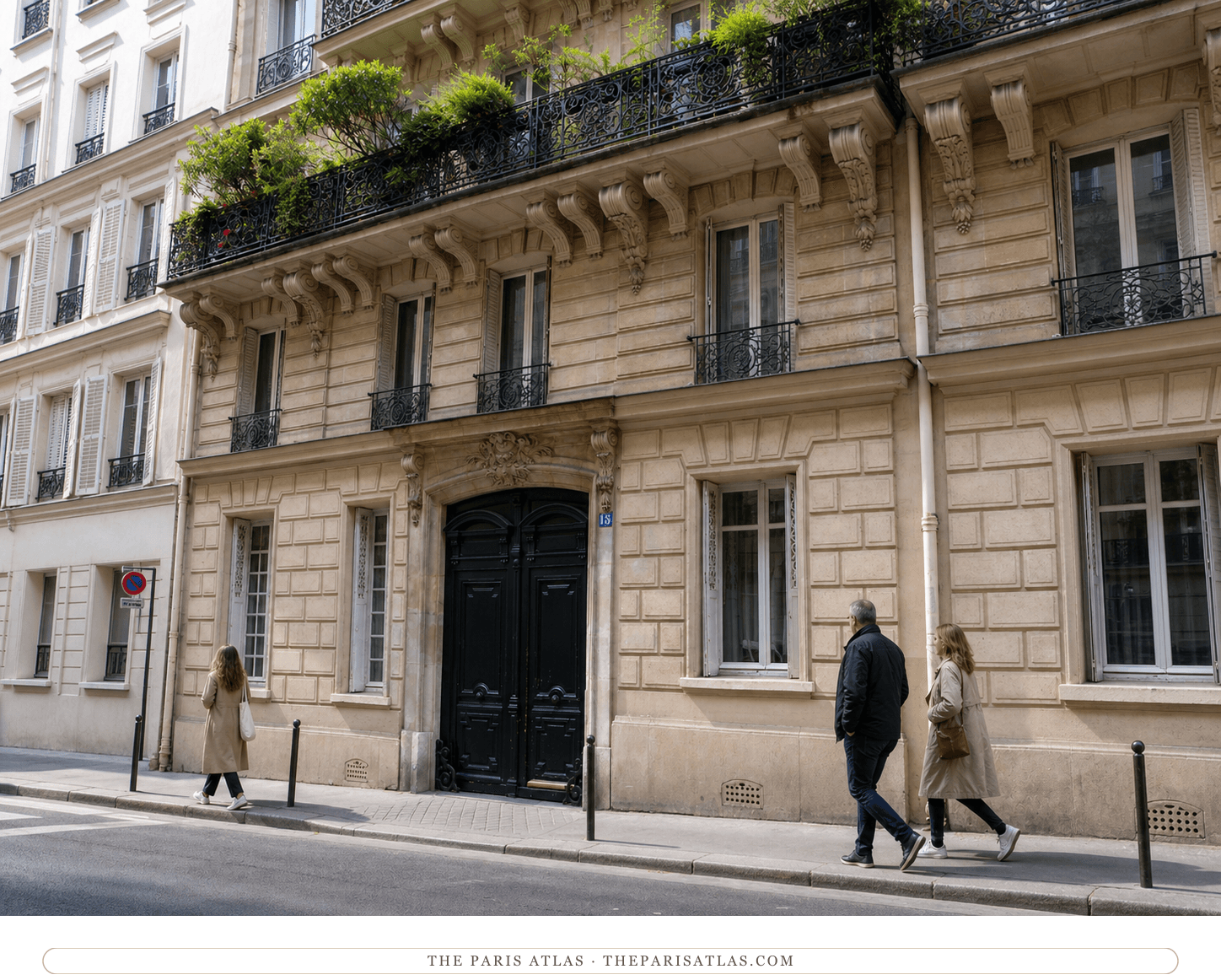 Color street view of the cream stone façade and dark carriage entrance at 15 rue La Bruyère