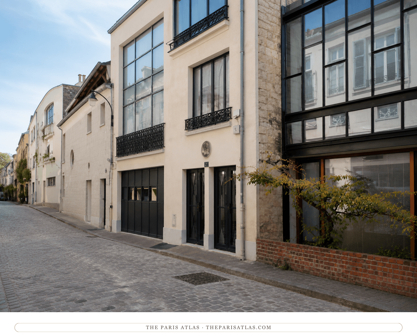 The Villa Seurat today — pale modernist façades, black-framed studio glazing, and cobbles down the private lane
