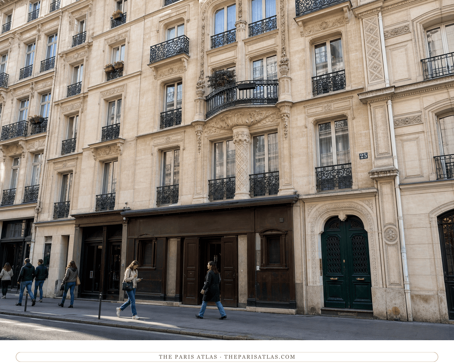 Color street view of the carved limestone, iron balconies and green entrance at 25 rue Victor-Massé