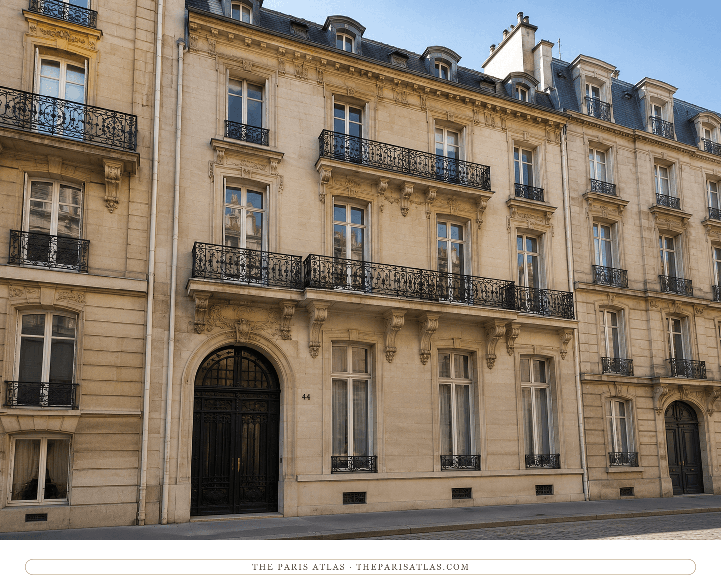 The same Haussmann-era façade in colour, in warm stone with black iron balconies