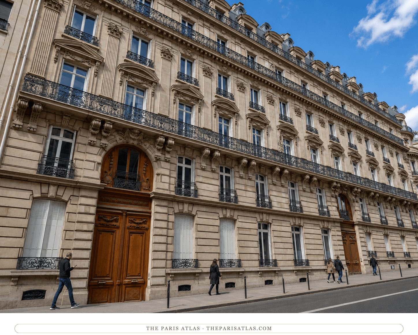 Color street view of the limestone façade, iron balconies and wooden doors at 45 rue de Courcelles