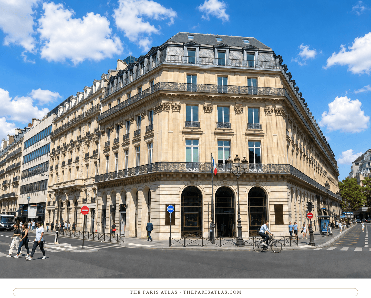 Present-day color view of the surviving honey-stone corner building at 11 rue Scribe under a blue sky, with the Nespresso boutique at street level