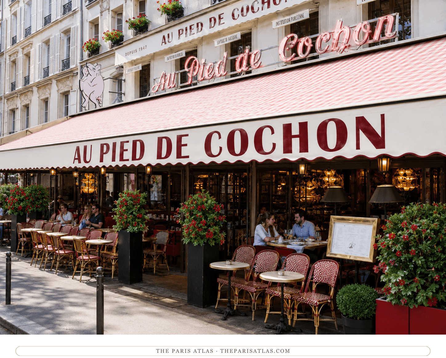 The same façade in colour, the awning red and cream under a neon script sign, geraniums in the planters and the terrace full in afternoon sun