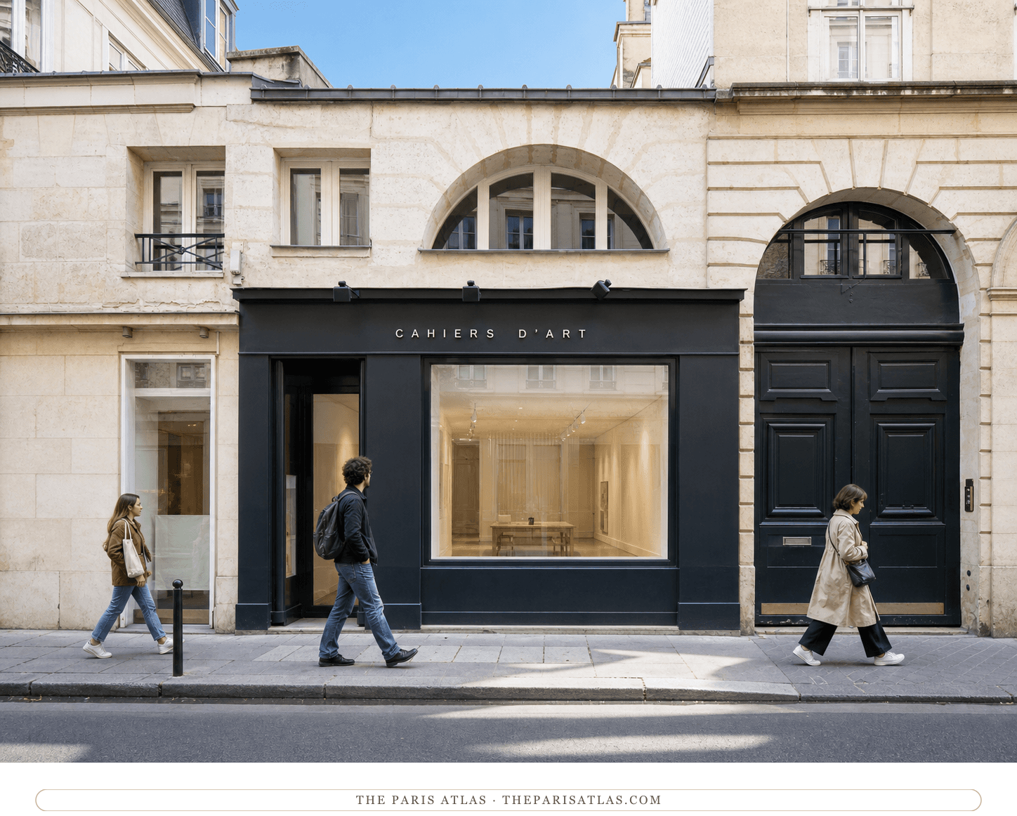 Bright present-day view of the dark Cahiers d'Art storefront beneath pale stone arches