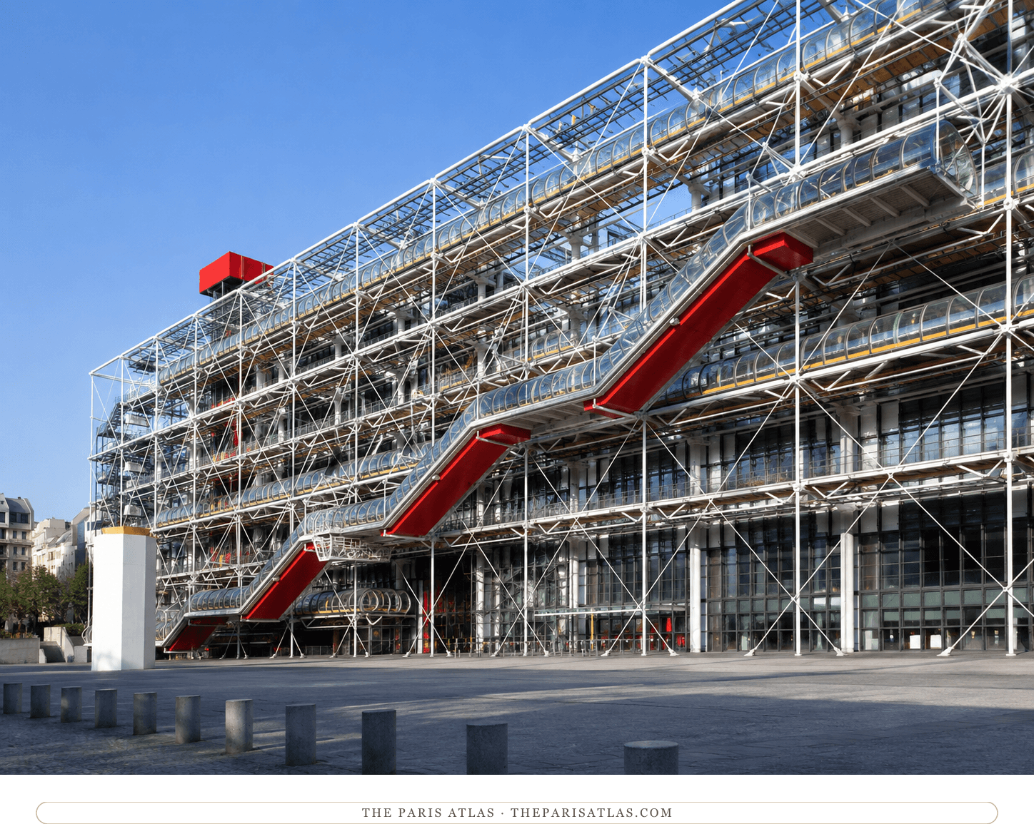 The Centre Pompidou's west façade under a clear sky: white steel lattice and glass, with the red escalator tube zigzagging up the front