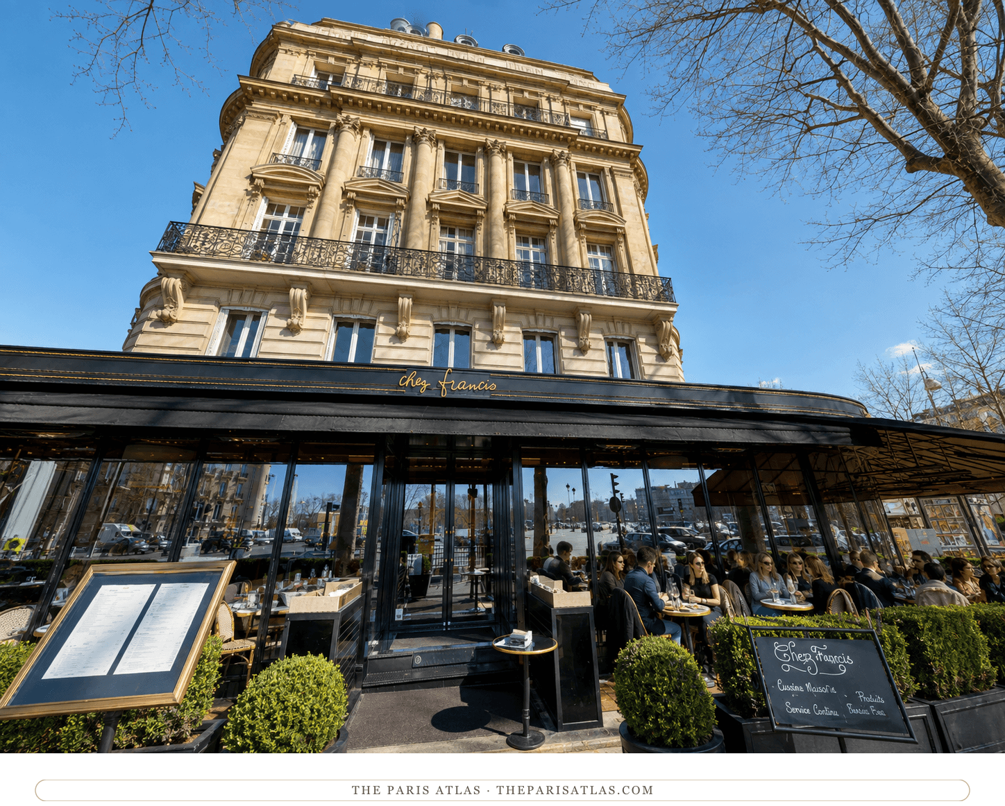 Chez Francis today — black awning, glassed-in terrace and hedge planters below the stone facade on the Place de l'Alma