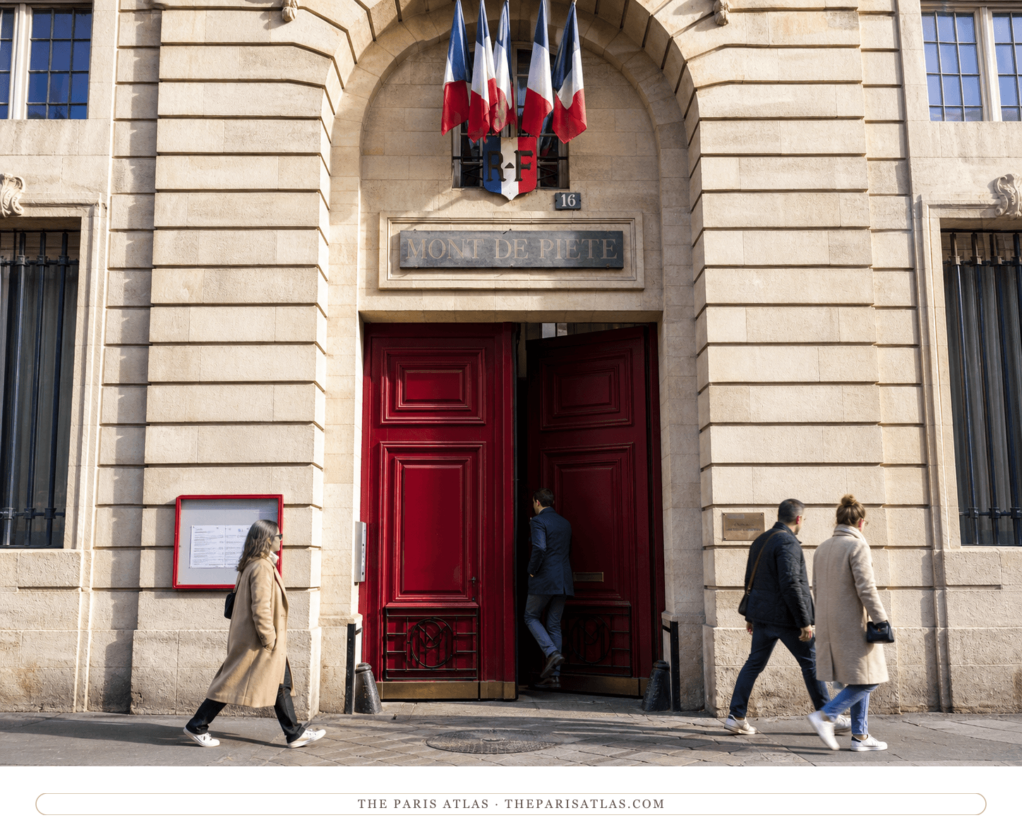Pedestrians passing the red doors of the Crédit Municipal de Paris