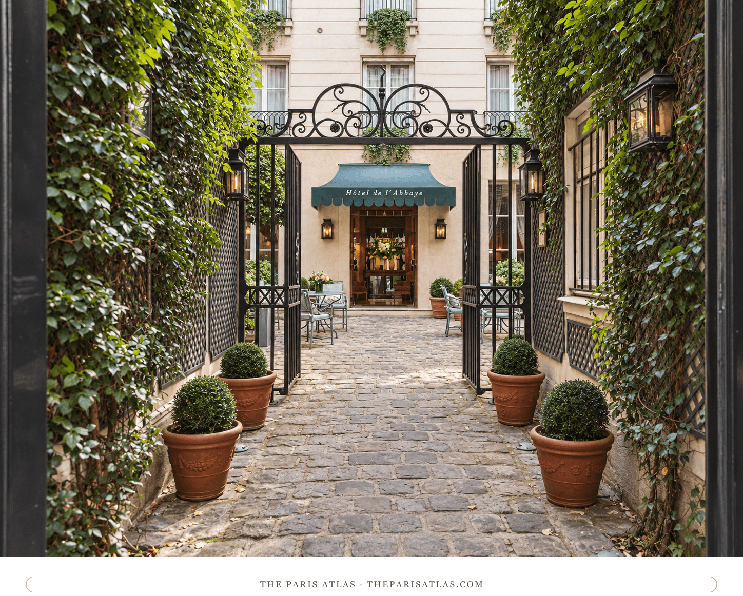 Illustration of Hôtel de l’Abbaye’s ivy-lined entrance courtyard, open iron gate and green awning.