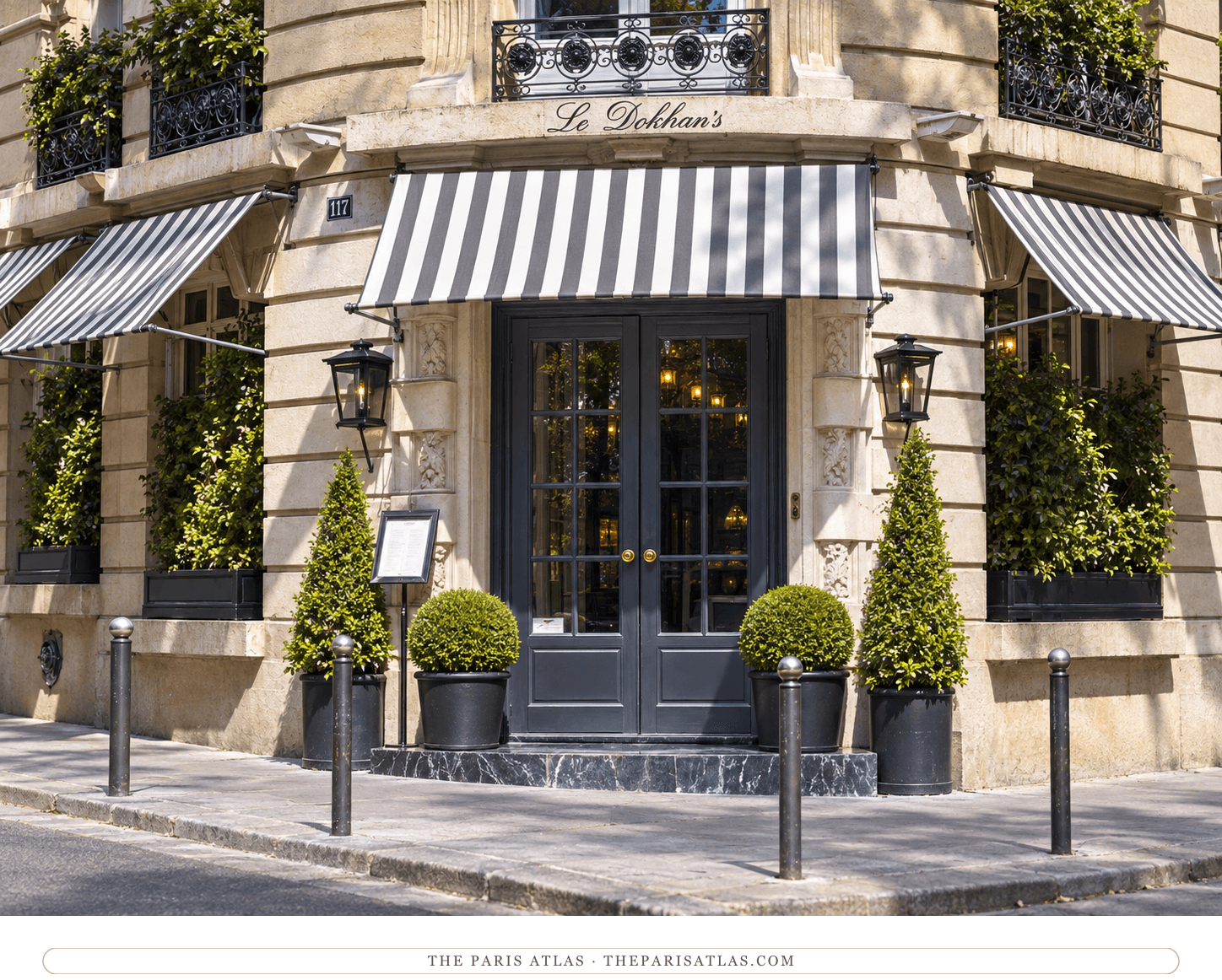 Illustration of Le Dokhan’s limestone entrance with striped awnings, dark doors and topiary.