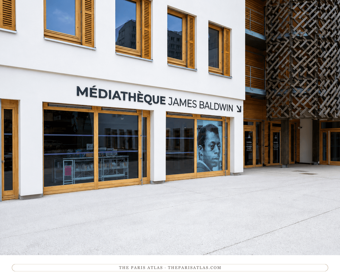 The Médiathèque James Baldwin today, white render and timber window frames with Baldwin's portrait in a glass bay and a woven timber screen on the neighbouring wing