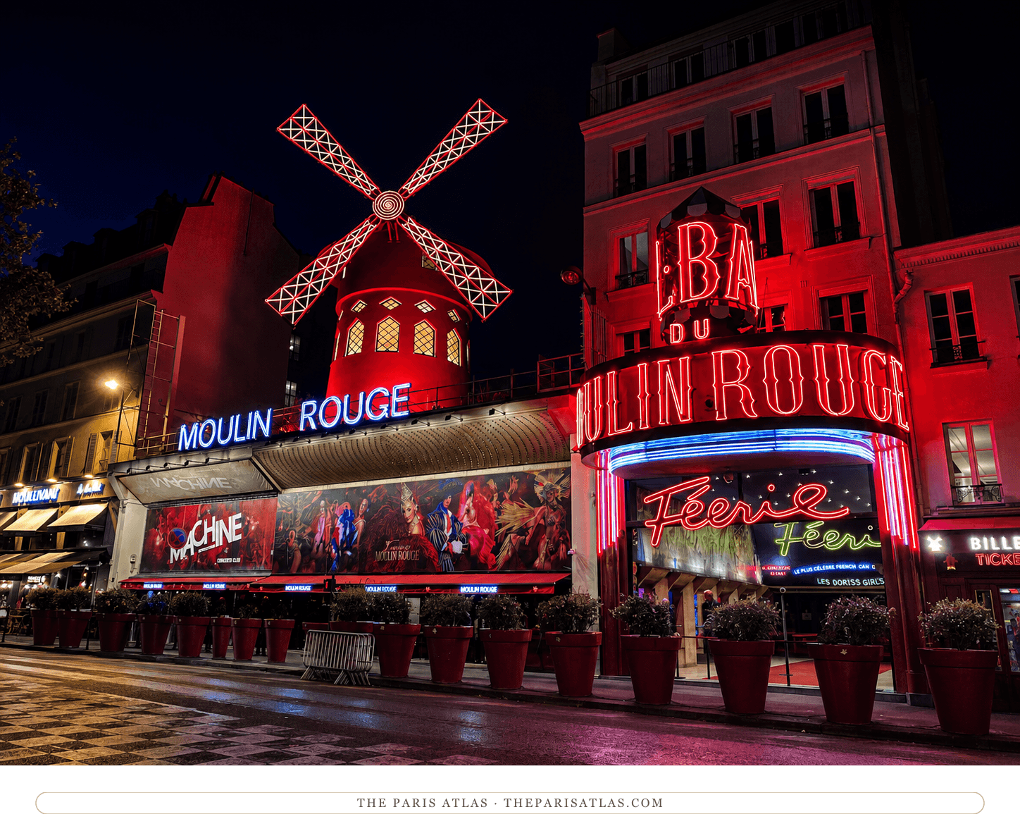 The Moulin Rouge lit red at night, the windmill and neon signage in colour