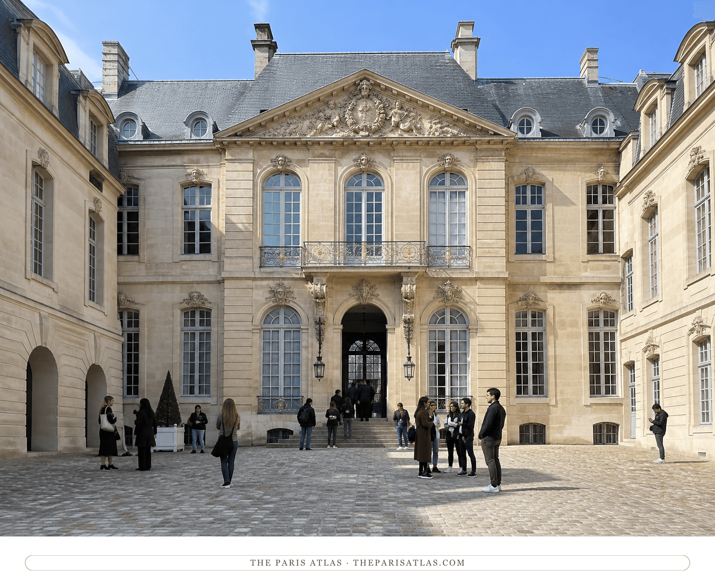Bright present-day color view of visitors in the Hotel Sale courtyard under a blue sky