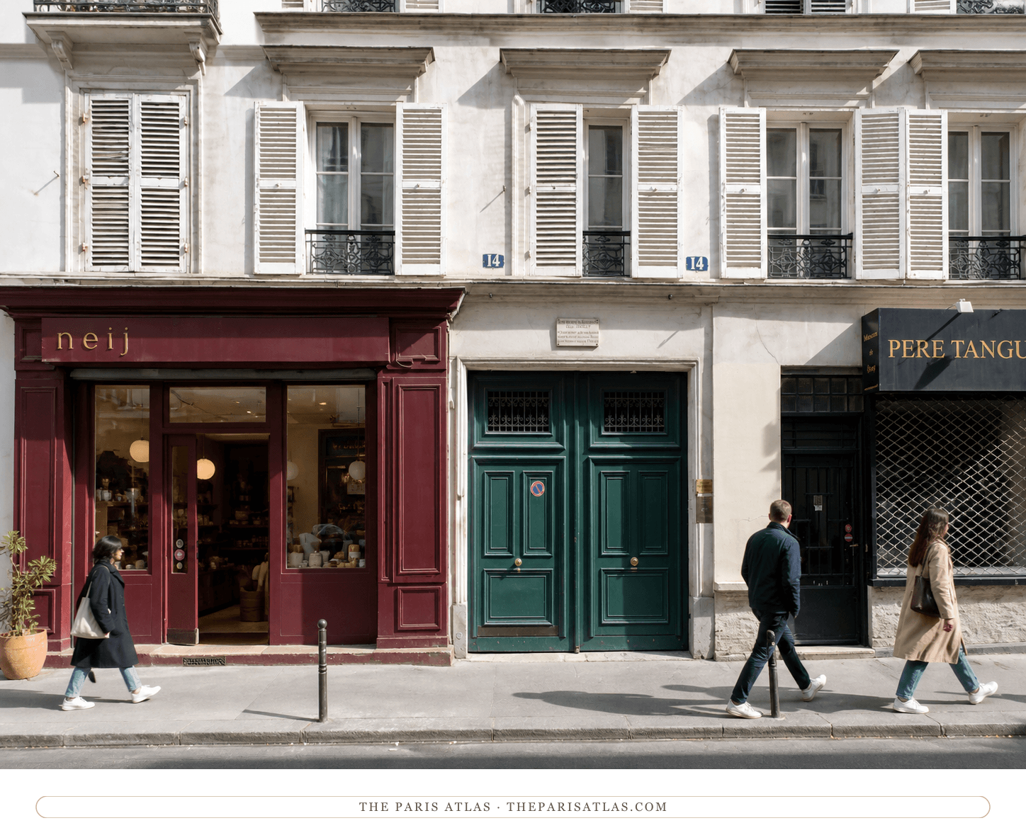 Bright present-day color view of the storefronts and green carriage doors at 14 rue Clauzel