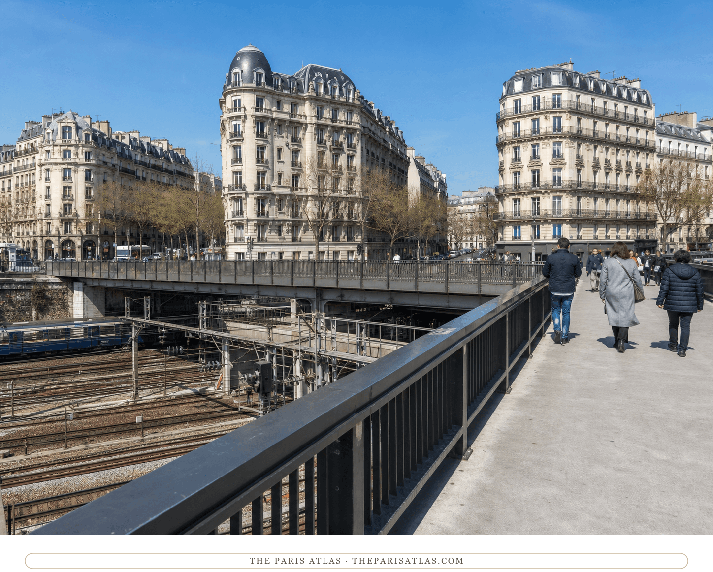 Bright present-day view of pedestrians crossing the Pont de l'Europe above the railway cutting