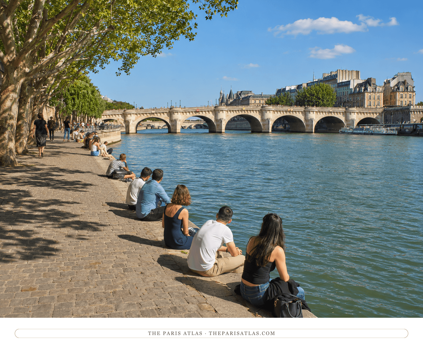The same view of the Seine in colour, green water under a pale sky